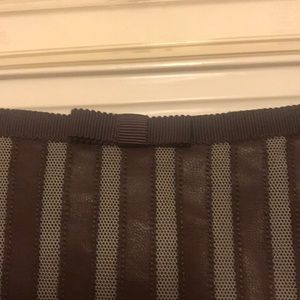 Mesh and leather-striped skirt.